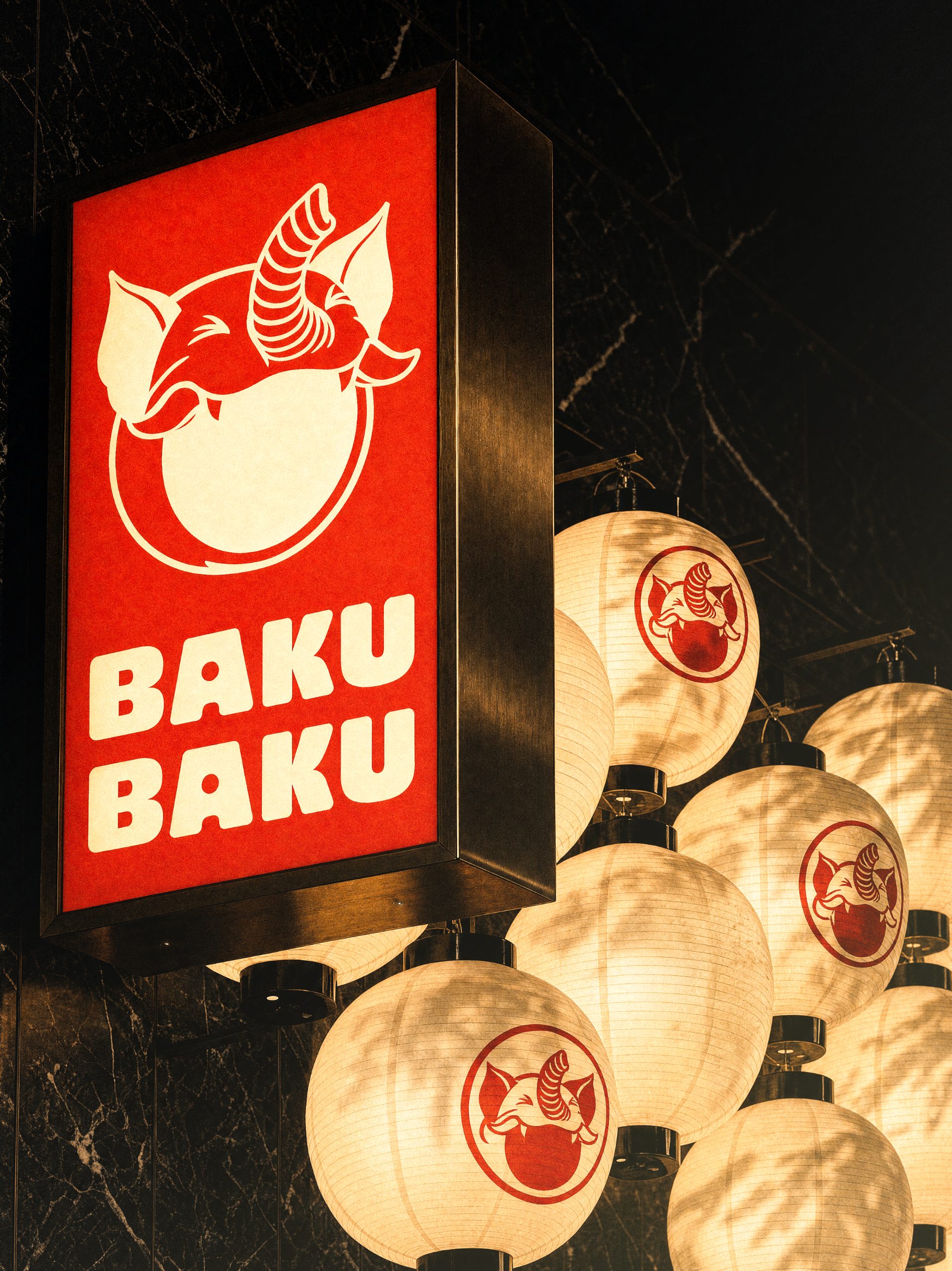 Baku Baku identity on a lightbox sign and paper lanterns