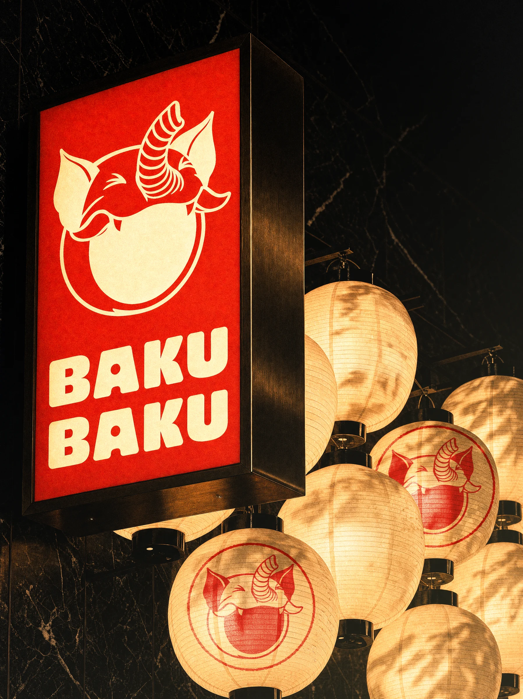 Baku Baku identity on a lightbox sign and paper lanterns
