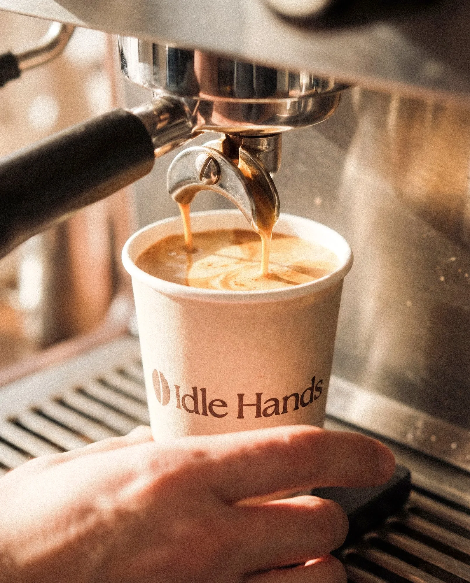 Idle Hands takeaway cup with the bean mark and the line Carefully brewed