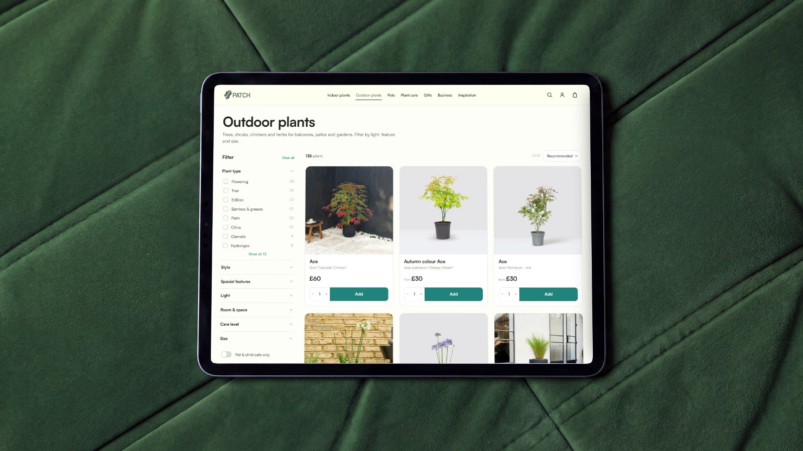 The Patch outdoor plants collection page on an iPad, laid on green velvet