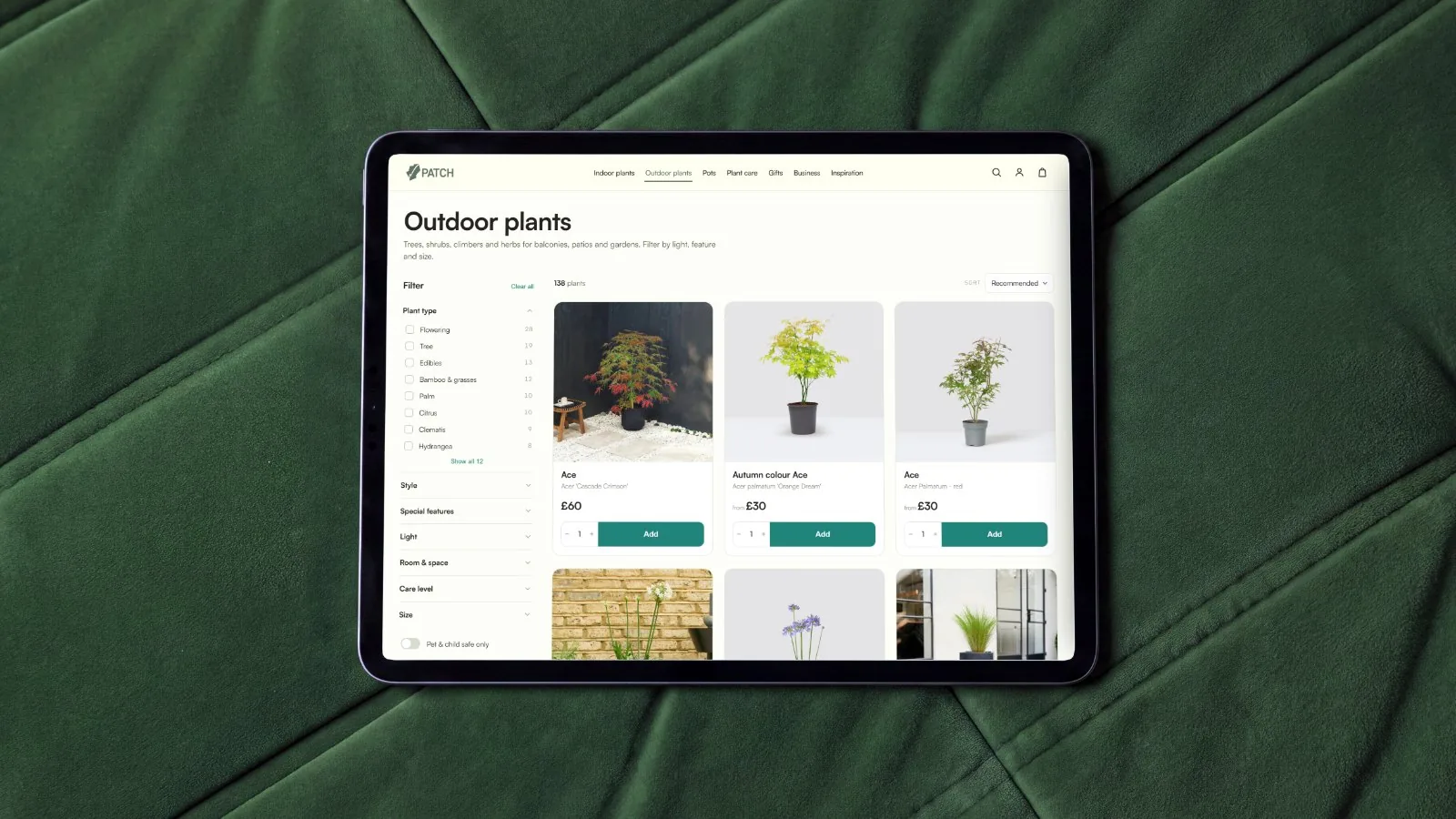 The Patch outdoor plants collection page on an iPad, laid on green velvet